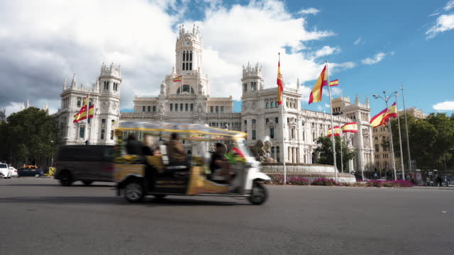 Electric tuk tuks for tourists and other vehicles circulating through the center of Madrid