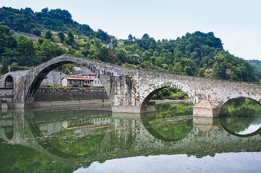 Moody reflections at Ponte della Maddalena, located in Lucca, Italy