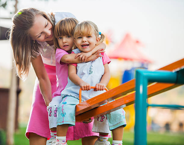 istock Mother with her daughters enjoying in playground. 175181939