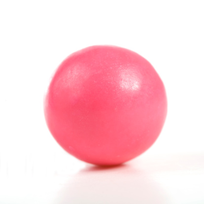Pink gumball on white