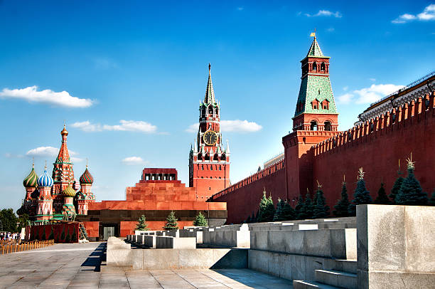 Red Square Lenin mausoleum and Moscow Kremlin "Beautiful view of Red Square, Lenin mausoleum, St Basils Cathedral and Moscow Kremlin. Beautiful blue sky with cumulus clouds on such a sunny day in Moscow. Copy Space for your text.See more images like this in:" onion dome stock pictures, royalty-free photos & images