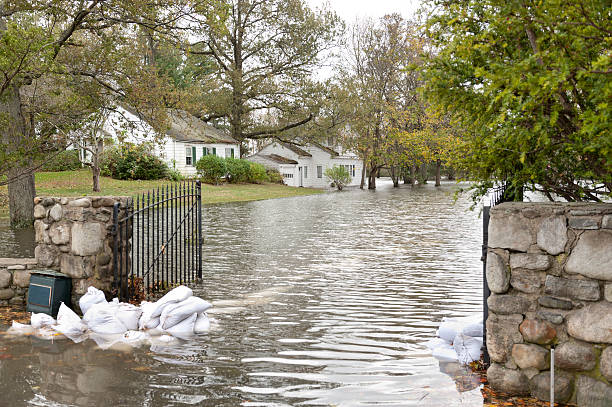 Flooded luxury house after Hurricane Sandy A flooded house in an oceanside community in New England shows the strength of Hurricane Sandy, a powerful storm which crashed into the Eastern USA. The gate was barricaded with sandbags, but the force of the water was too strong. superstorm stock pictures, royalty-free photos & images