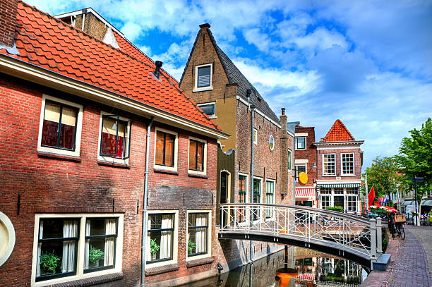 Typical Dutch Architecture "Typical Dutch Architecture, Gouda, Netherlands. Visible are many beautiful dutch houses, restaurants, bridges and many beautiful canals all over the town." gouda south holland stock pictures, royalty-free photos & images