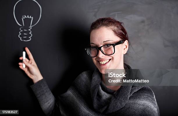 Young Woman In Front Of A Chalkboard Stock Photo - Download Image Now - Adult, Beautiful People, Beautiful Woman