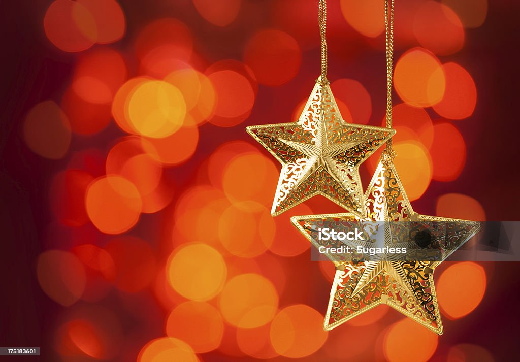Christmas decorations Christmas star-shaped ornaments over red background Bright Stock Photo