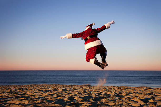 Santa Claus Happy on Vacation at the Beach This is a conceptual photo relating to taking a Christmas vacation. san diego photos stock pictures, royalty-free photos & images