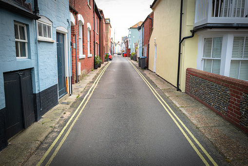 Shallow focus of a narrow English seaside street with double yellow lines either side.