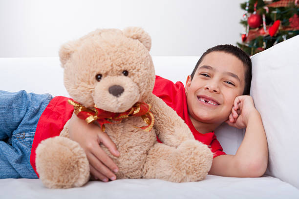 istock Christmas-Smiling boy hugging teddy bear 175184360