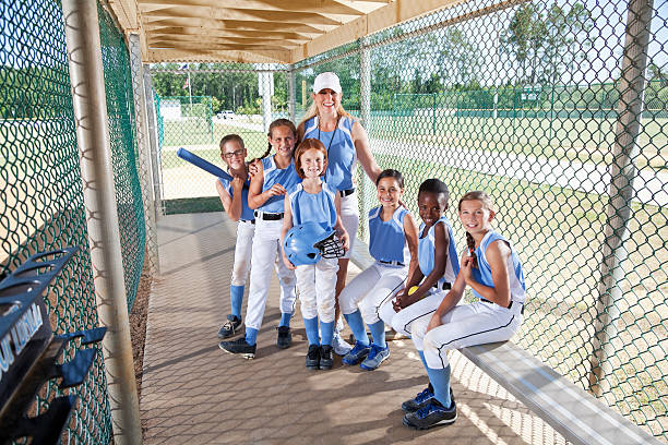 istock Girls softball team in dugout with coach 175184567