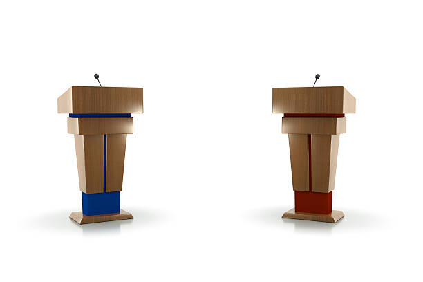 polictcal debate Two Podiums facing each other one blue one red.Isolated on white.Could be a useful image for a debate composition.This is a detailed 3d rendering. debate stock pictures, royalty-free photos & images