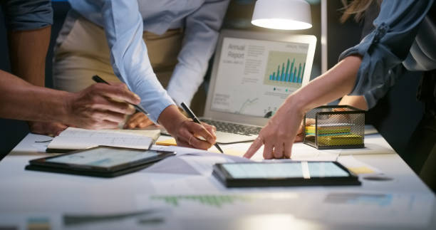 istock People, meeting and night charts or laptop data analytics, for statistics research, budget report or teamwork. Group of hands with tablet, digital or computer screen and writing or planning of graphs 1751848528