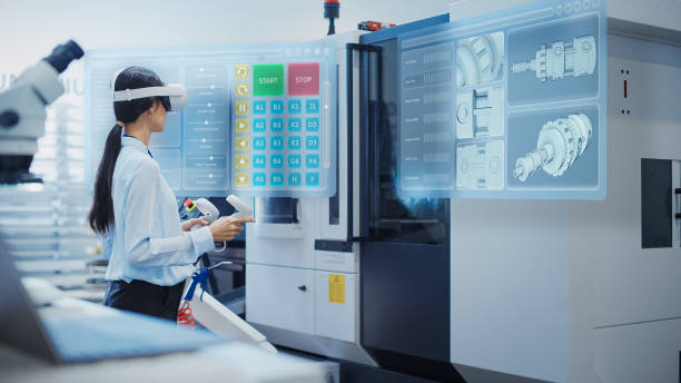 istock Female Engineer Wearing a Virtual Reality Headset and Operating a Heavy Industry Machine with Controllers at a Factory. Digital Visualization of a Technician Configuring Industrial Machinery with VR 1751850718