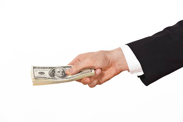 istock businessman giving money 175185220