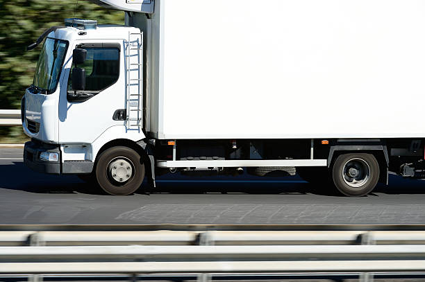 istock Motion blurred white truck on two lane highway 175185225
