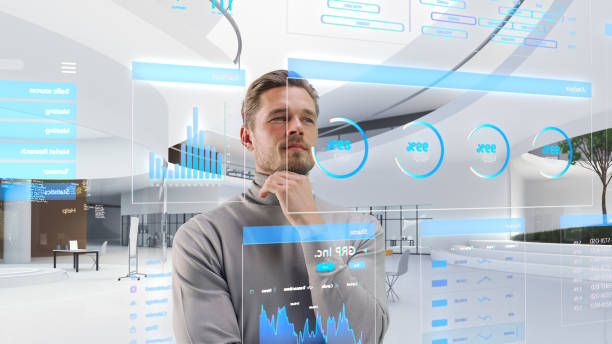 istock Handsome Man Standing in Futuristic Virtual Space, Interacting with an Augmented Reality Hologram with Business Data, Financial Reports, Stock Market Statistics, Infographics, Charts 1751852470