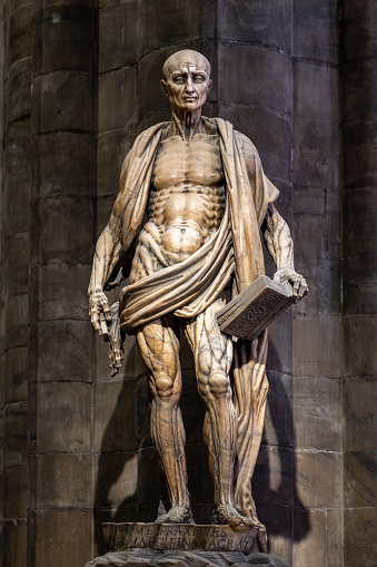 Statue of St. Bartholomew, one of 12 Apostles. Inside the Duomo di Milano Cathedral - Milano, Italy. August 6, 2023
