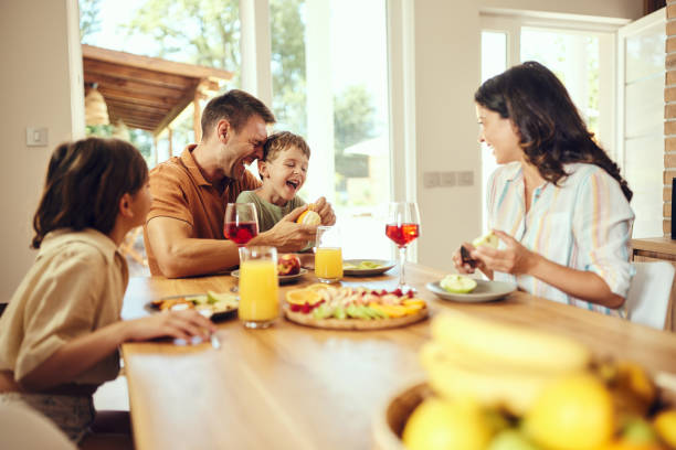 istock Cheerful family having fun during a meal at dining table. 1751859364