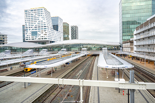 Station Utrecht Centraal, Utrecht Centraal railway station with trains arriving and departing. Utrecht central station is the biggest train station in the Netherlands, because of its central location in the Netherlands, Utrecht Centraal is the most important railway hub in Holland.