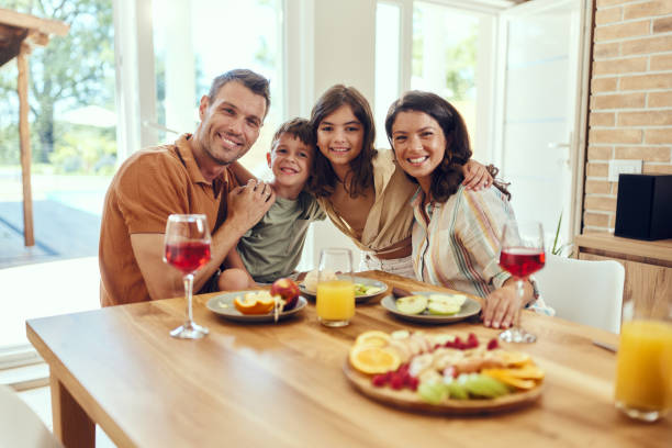 istock Happy family enjoying during a meal at dining table. 1751859687