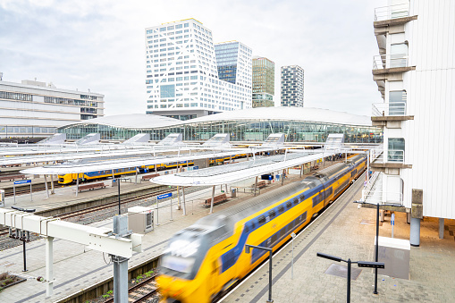 Station Utrecht Centraal, Utrecht Centraal railway station with trains arriving and departing. Utrecht central station is the biggest train station in the Netherlands, because of its central location in the Netherlands, Utrecht Centraal is the most important railway hub in Holland.