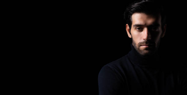 istock Bearded handsome young cool business man portrait Attractive bearded confident guy planning something looking at camera Smart man stand in the dark room Confident Cool man looking at camera copy space 1751859831