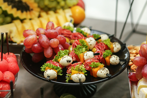Catering buffet table with snacks and appetizers. Set of varios fruits and berries. Wedding event