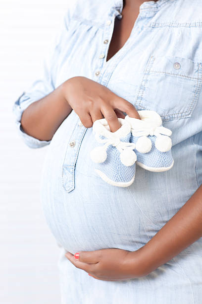 istock Pregnancy woman's belly with baby booties. 175186261