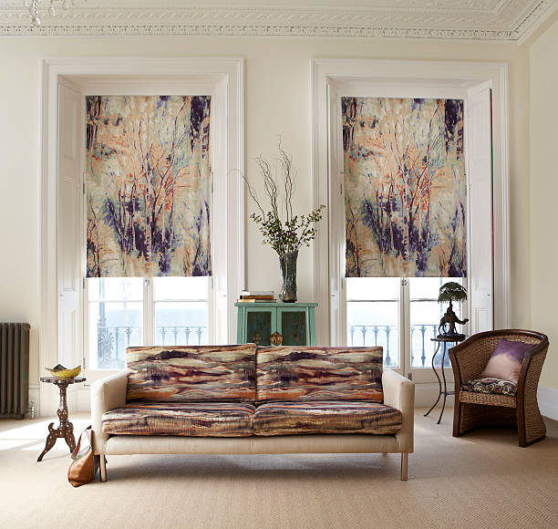 Beautiful blinds in large French windows with a modern settee in the foreground set in a stylish lounge