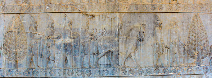 Ancient bas-relief from Persepolis. The Sacae bring gifts and tribute to the Persian king