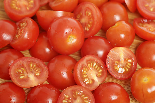Green tomato.Ripe cut tomatoes on cutting board