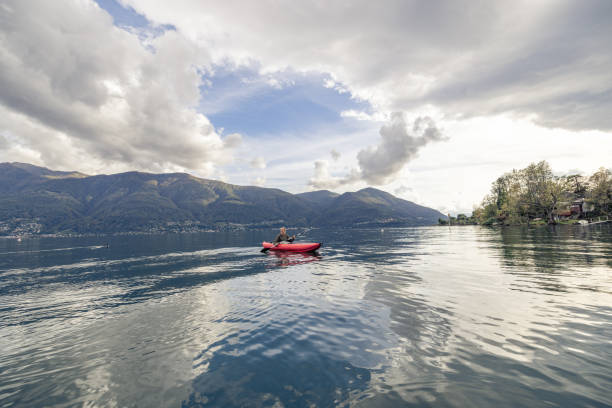 istock Woman canoeing on calm lake 1751870863