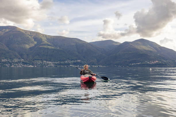 istock Woman canoeing on calm lake 1751870864