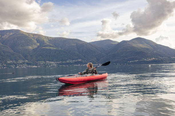 istock Woman canoeing on calm lake 1751871405