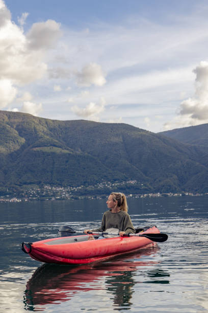 istock Woman canoeing on calm lake 1751871416