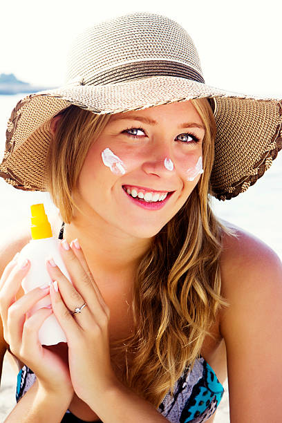 istock Beautiful young woman with suntan lotion 175187528