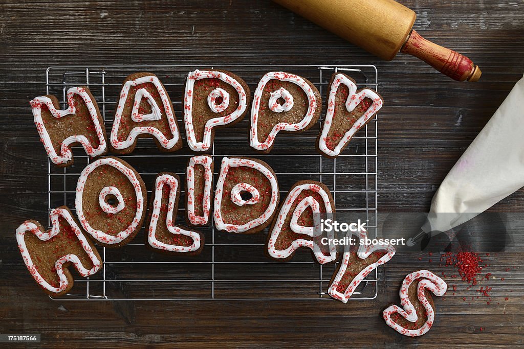 Cookie Holiday Greeting Freshly baked and decorated gingerbread cookies on a cooling rack spell out a holiday greeting.More images from this series: Baked Stock Photo