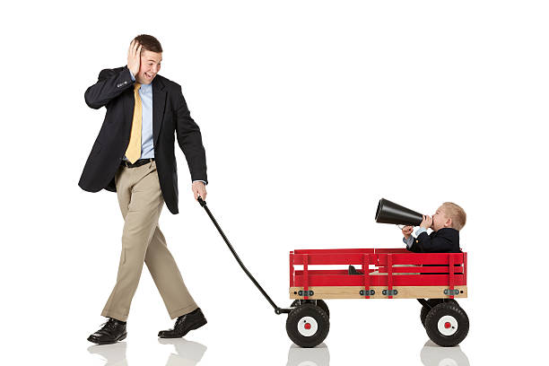 istock Father pulling his son in cart blowing a bullhorn 175187645