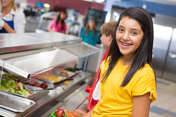 istock Cute young student in her cafeteria lunch line 175187917