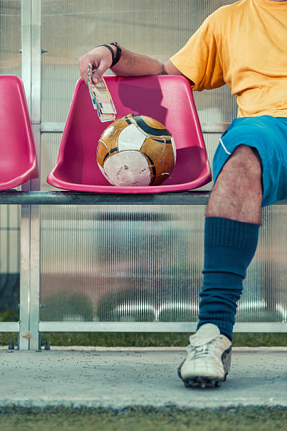 istock Corrupted professional soccer player taking money 175187985