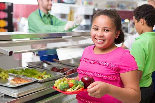 istock Elementary school age girl making healthy lunch choices in cafeteria 175188027