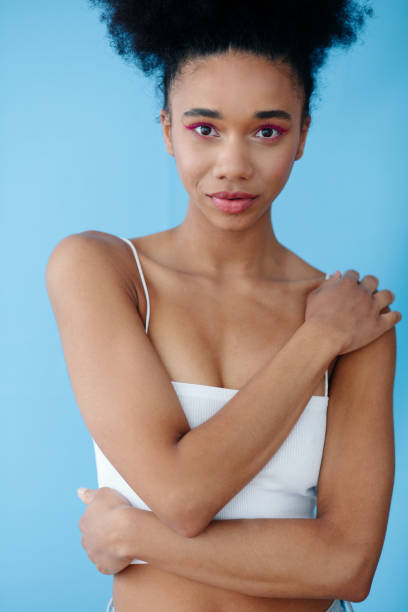 istock Young beautiful girl posing in studio over blue background. 1751883791