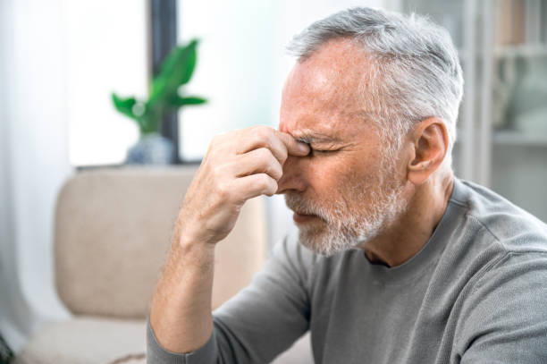 istock tired mature man suffering from headache at home 1751886226
