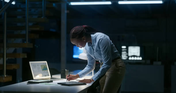istock Business woman, night and documents, computer or information technology research, programming or software solution. Programmer or coding expert with cybersecurity policy, writing or planning strategy 1751886791