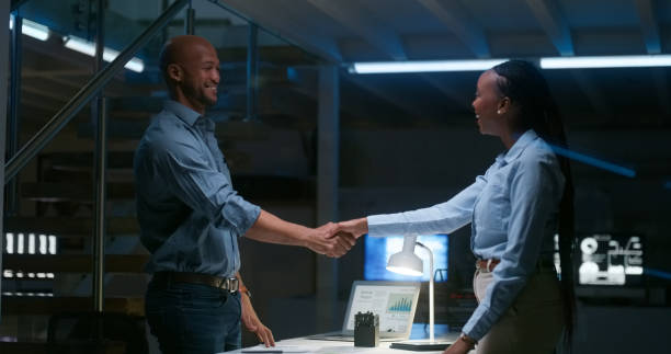 istock Business people, night meeting and handshake for data analysis success, congratulations or profit achievement. Professional manager shaking hands with analyst, woman or expert for statistics or deal 1751889538