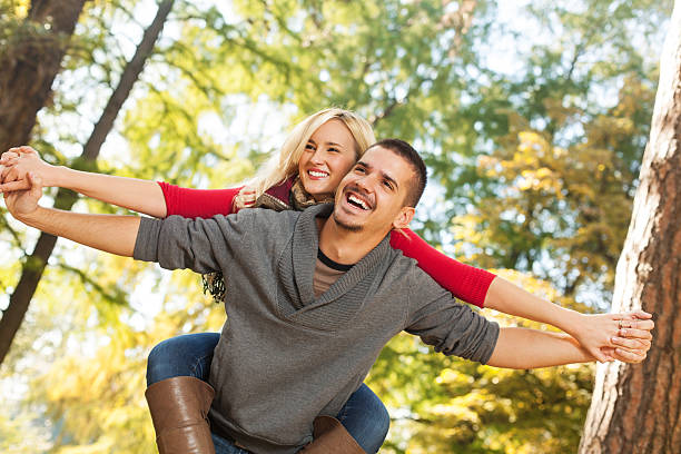 istock Man giving his girlfriend a piggyback ride 175189043
