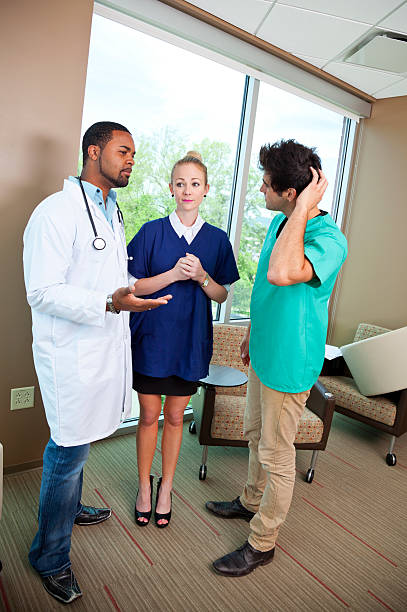 istock Doctor discussing with paramedic and nursing assistant 175189086
