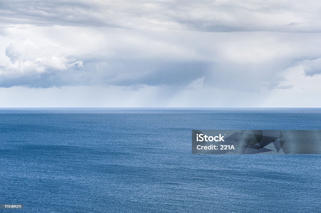 Baltic Sea and rain clouds "Distant light rain clouds over the Baltic Sea, with a pattern of ripples and small waves in the water, driven outwards by a south-westerly breeze. Cool blue tone.Baltic Sea coast:" Baltic Sea Stock Photo