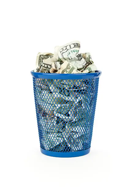 "Wasted money concept. Wastepaper basket full of money, isolated on white.Please also see:"