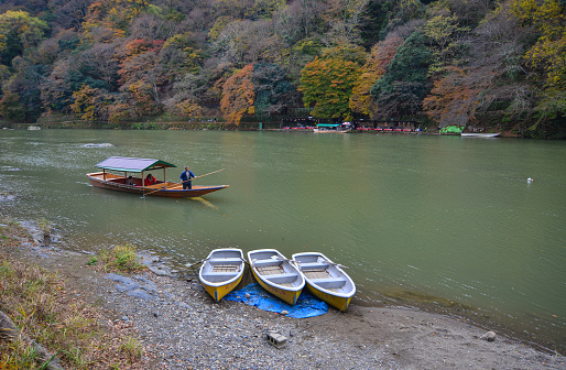 Kyoto, Japan - Nov 28, 2016. Autumn scenery of Hozu River at Arashiyama in Kyoto, Japan. Arashiyama is a nationally designated Historic Site and Place of Scenic Beauty.