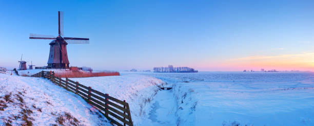 Traditional Dutch windmills on a cold winter evening.